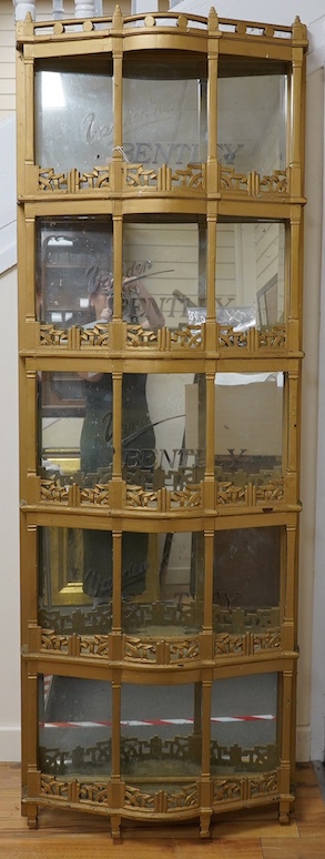 A 1920s gold-painted and mirror backed bow fronted Vanden Plas Bentley mirror-backed automobile showroom display unit, with five galleried shelves in an Art Deco style, each with bevelled mirrors behind and applied lette